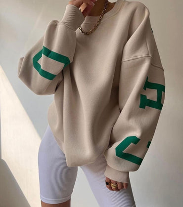 Woman wearing a printed thick long sleeve hoodie, looking cozy and stylish.

