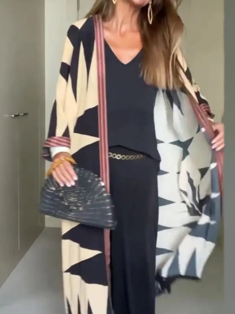 Model wearing printed long cardigan with jeans and boots

