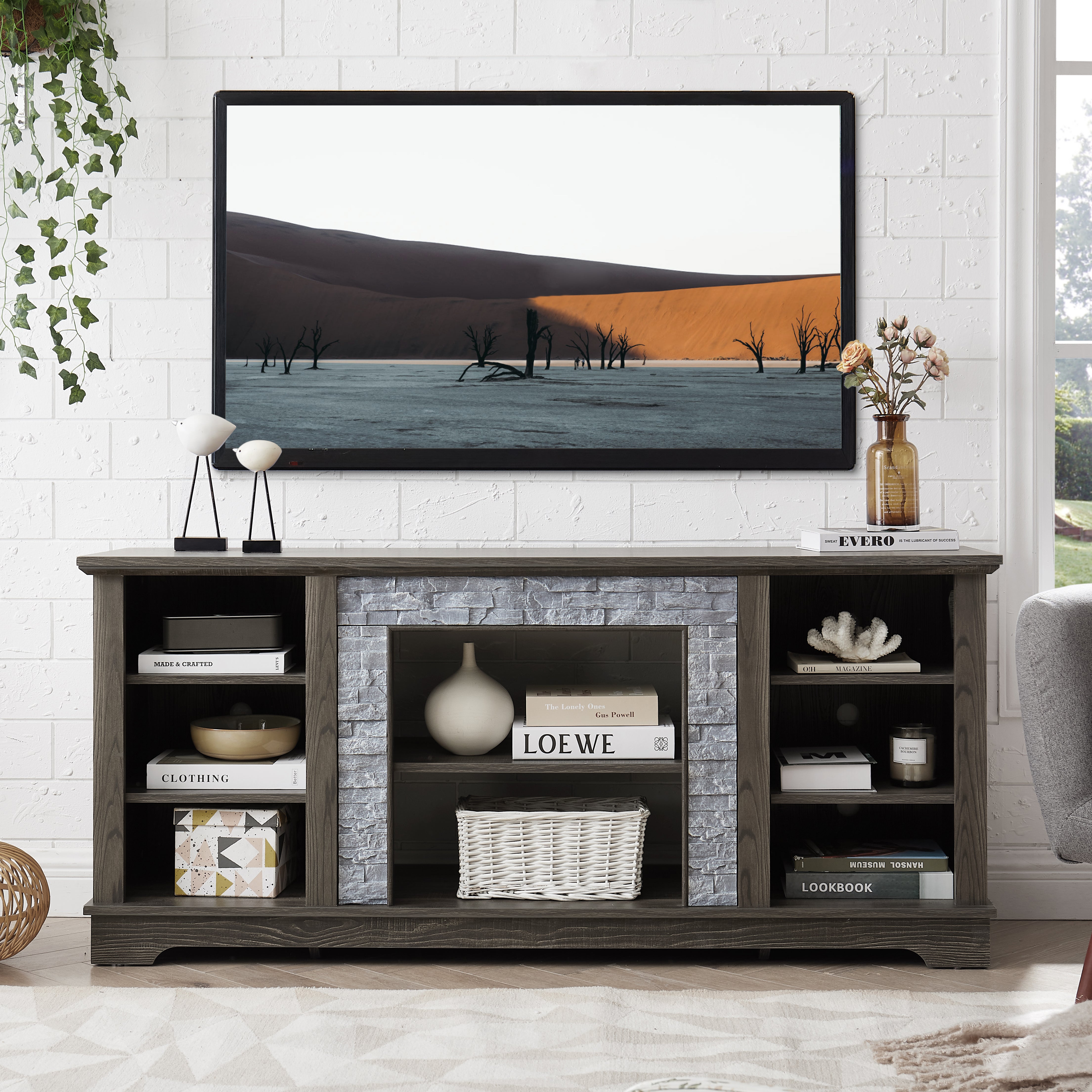 Modern gray stone TV console with open shelves and stacked stone frame