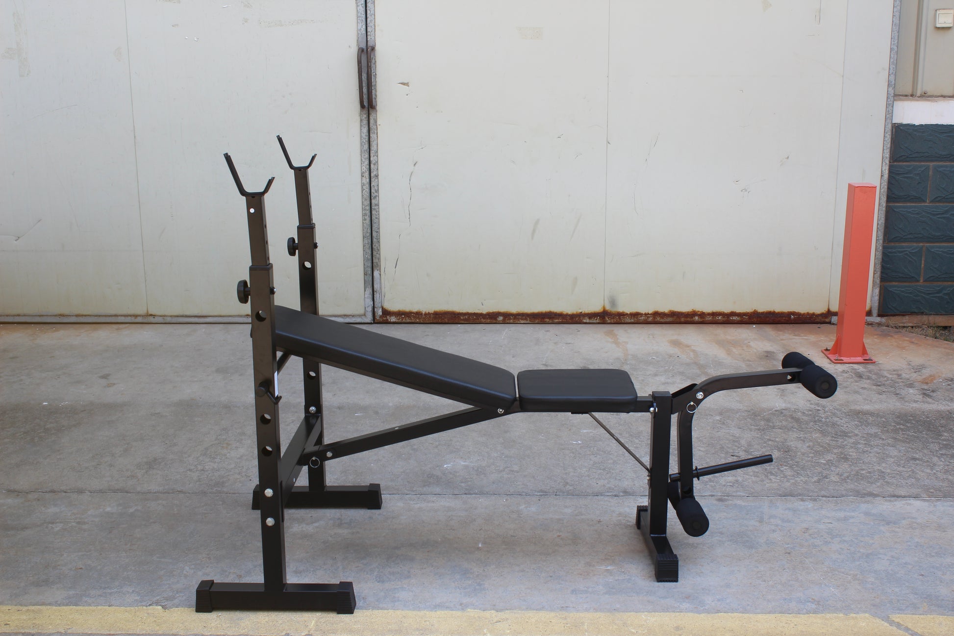Olympic weight bench with adjustable squat rack, designed for strength training, featuring sturdy construction and multiple settings for bench press, squats, and other weightlifting exercises.