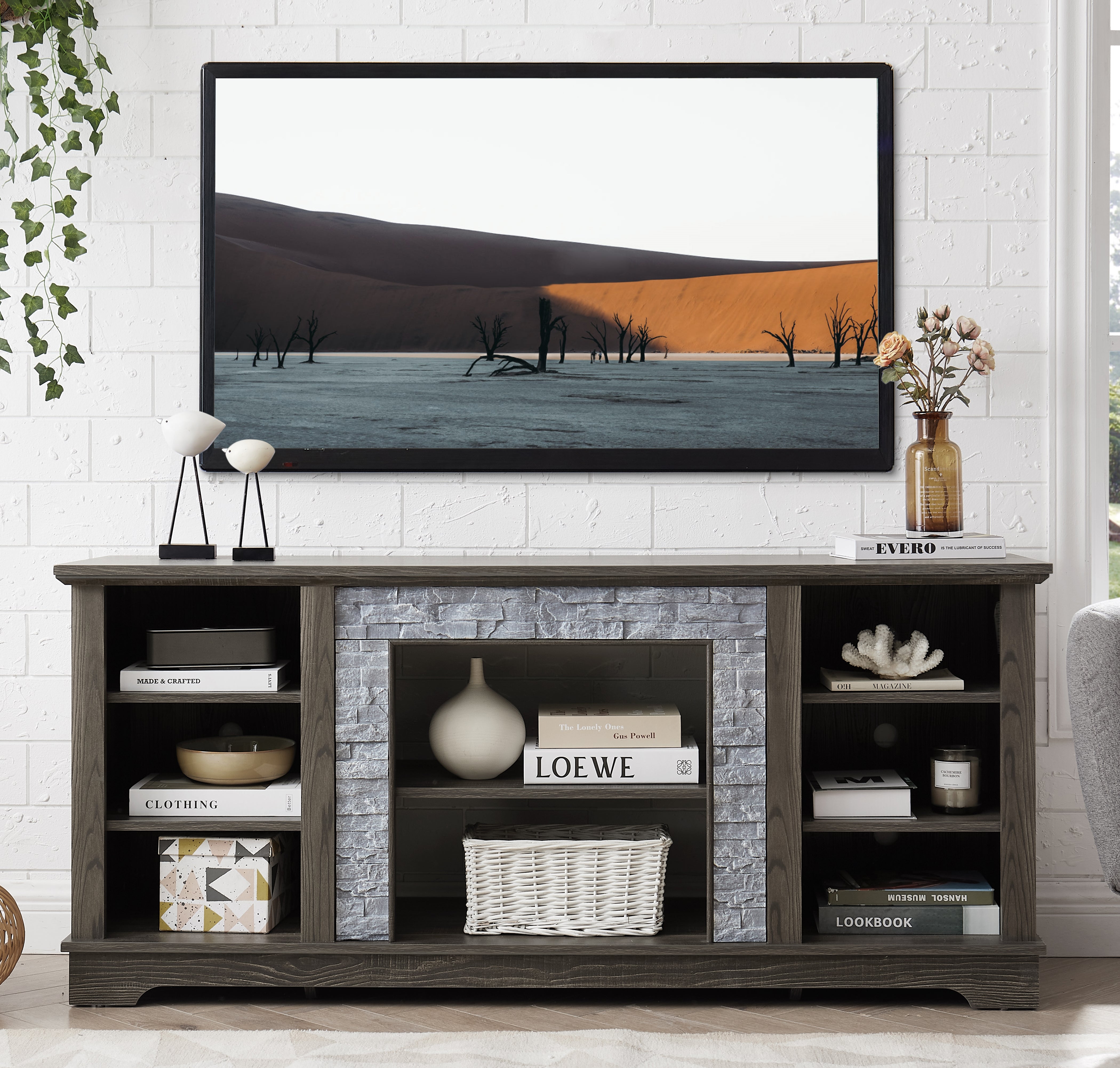 Modern gray stone TV console with open shelves and stacked stone frame