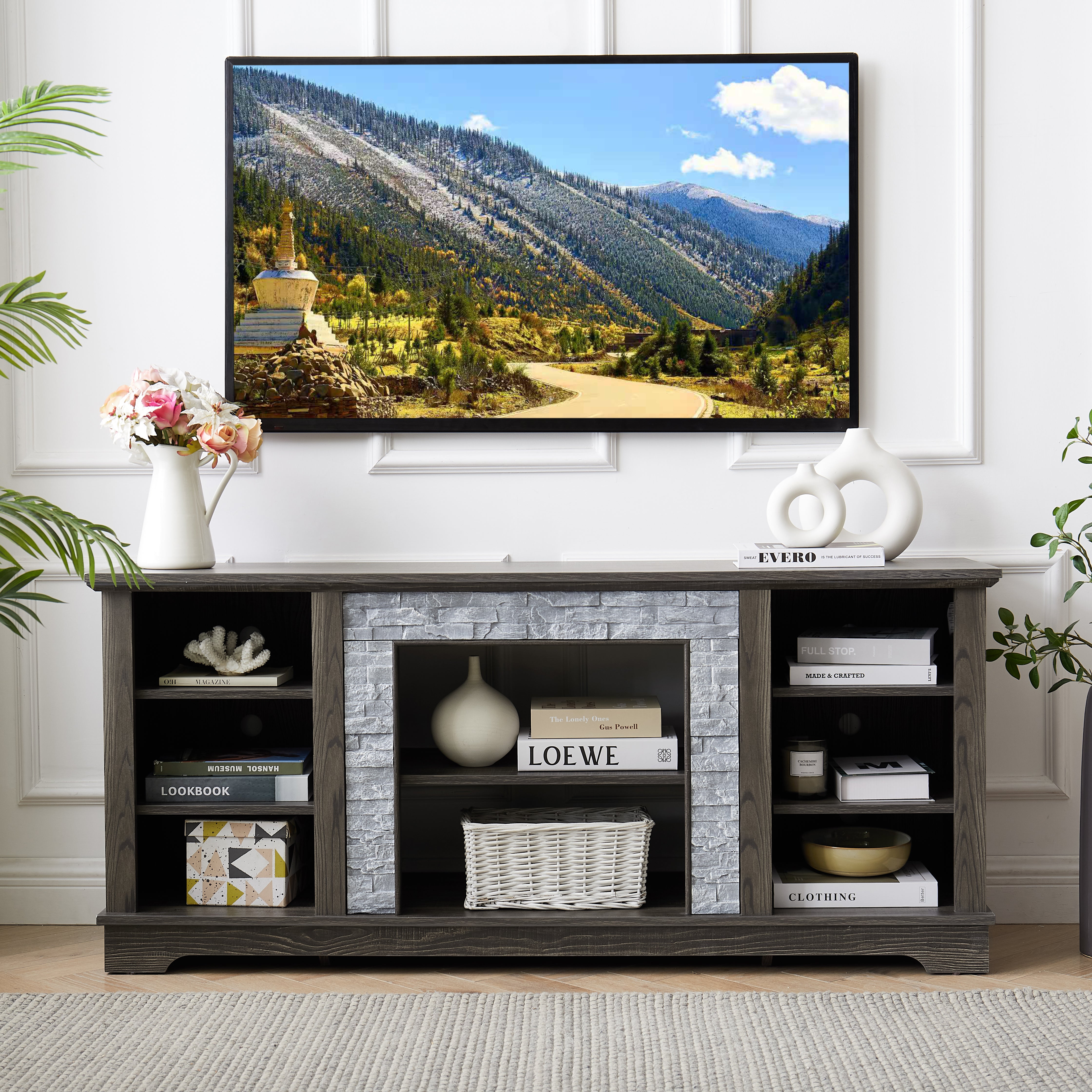 Modern gray stone TV console with open shelves and stacked stone frame