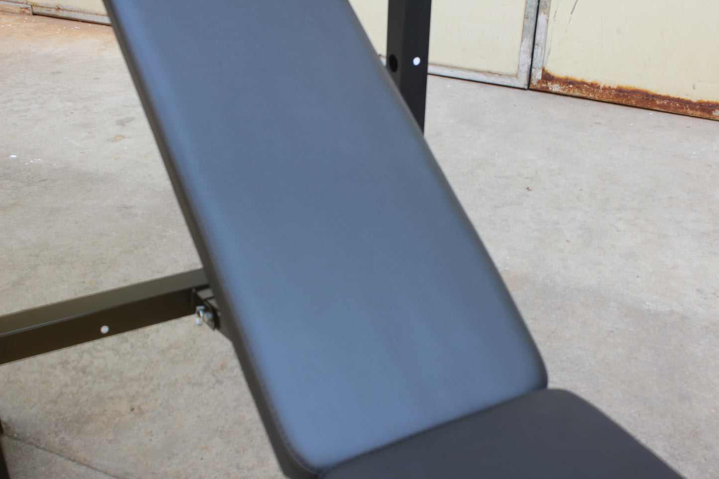 Olympic weight bench with adjustable squat rack, designed for strength training, featuring sturdy construction and multiple settings for bench press, squats, and other weightlifting exercises.