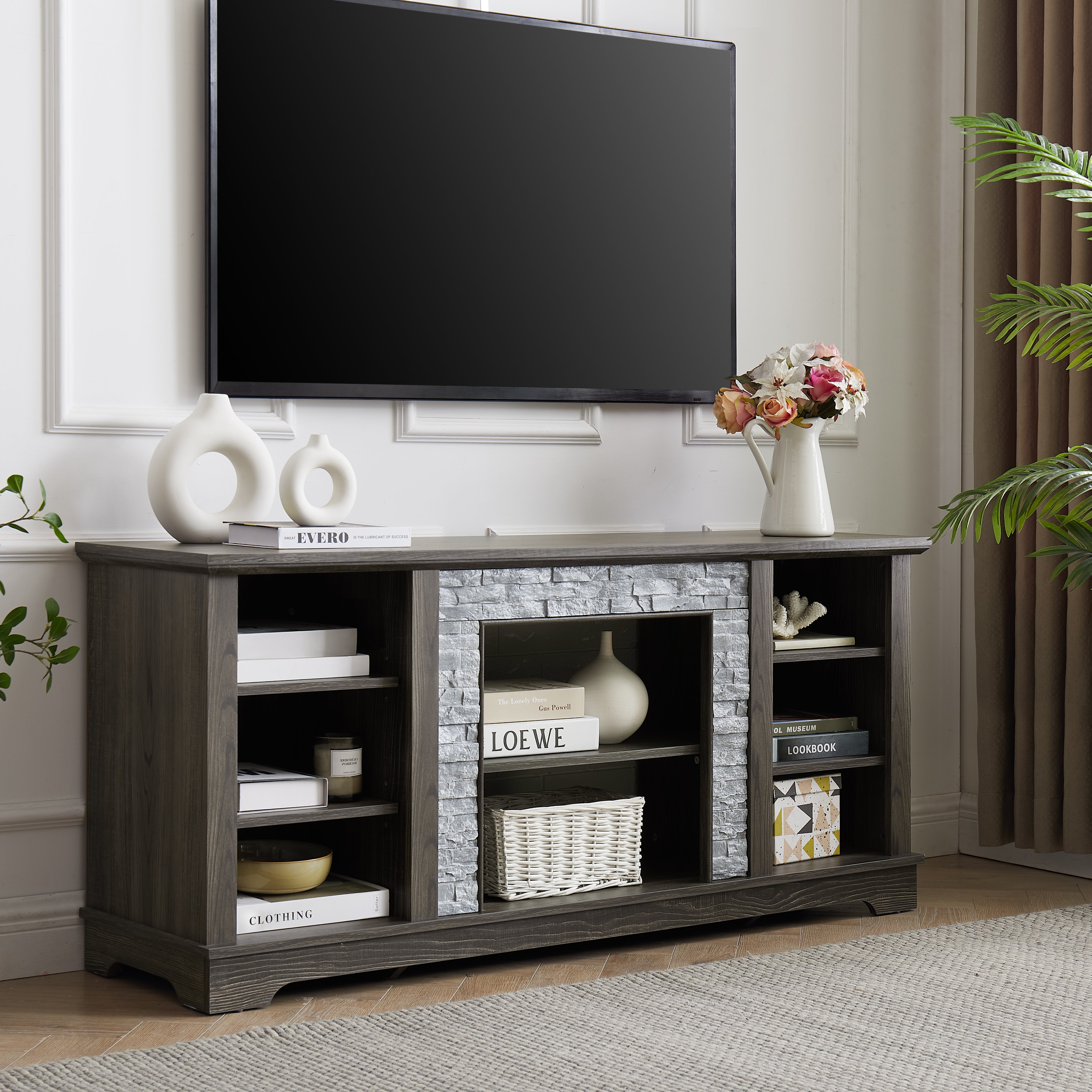 Modern gray stone TV console with open shelves and stacked stone frame