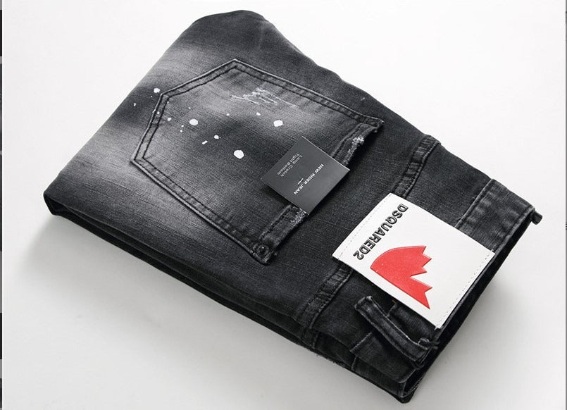 Men’s black and gray distressed jeans with torn holes and zipper decoration.

