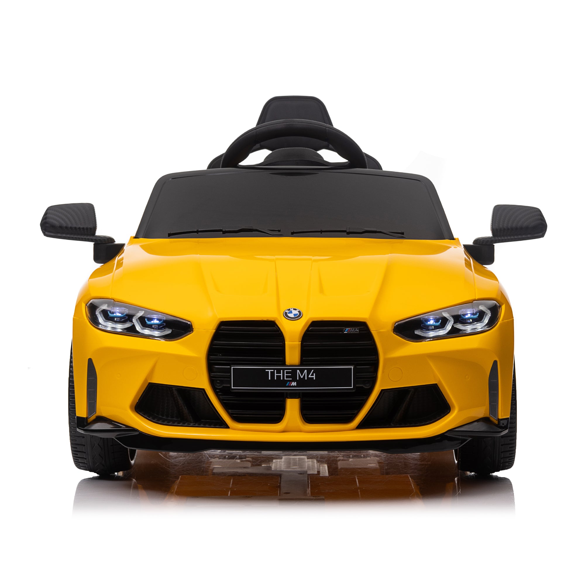Yellow BMW M4 12V electric ride-on car for kids, featuring authentic design with working headlights, MP3 player, and forward/reverse motion. Comes with adjustable seat and steering wheel, providing a realistic driving experience for children aged 3-6