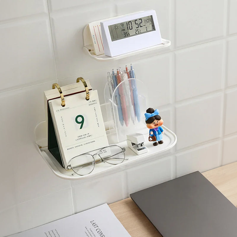 Wall-mounted plastic floating shelf in a modern bathroom holding towels