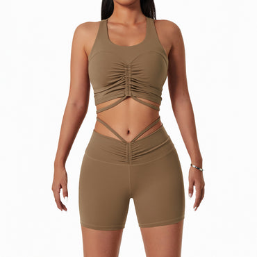 Woman wearing a stylish yoga set with drawstring collar top and fitted leggings, ideal for gym or yoga sessions.

