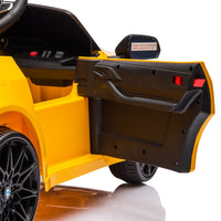 Yellow BMW M4 12V electric ride-on car for kids, featuring authentic design with working headlights, MP3 player, and forward/reverse motion. Comes with adjustable seat and steering wheel, providing a realistic driving experience for children aged 3-6