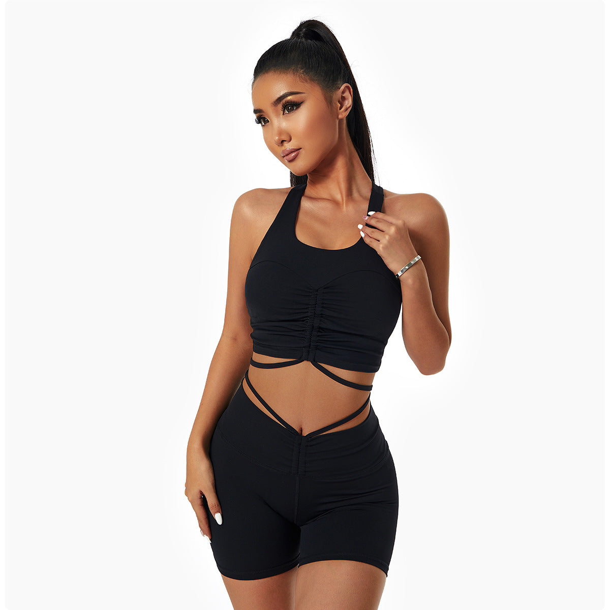 Woman wearing a stylish yoga set with drawstring collar top and fitted leggings, ideal for gym or yoga sessions.

