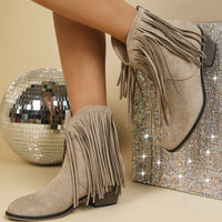 Women’s retro chunky heel Martin boots with pointed toe and tassel details.

