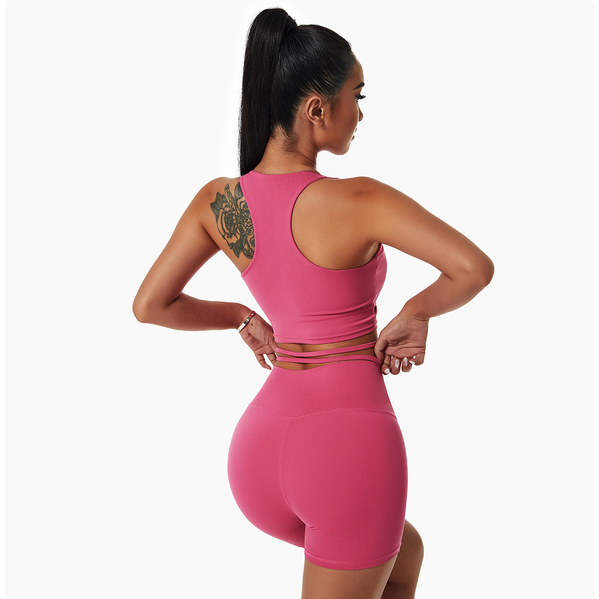 Woman wearing a stylish yoga set with drawstring collar top and fitted leggings, ideal for gym or yoga sessions.

