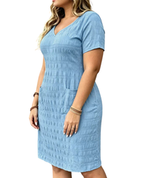 A woman wearing a light blue textured short-sleeve V-neck dress with side pockets, shown from the waist down against a plain white background.
