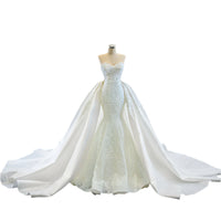 Elegant strapless tube top wedding dress with a fishtail silhouette, detachable flowing train, and intricate lace details for a dreamy bridal look.

