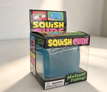 Squish Cube packaging with blue squishy toy inside on a white background