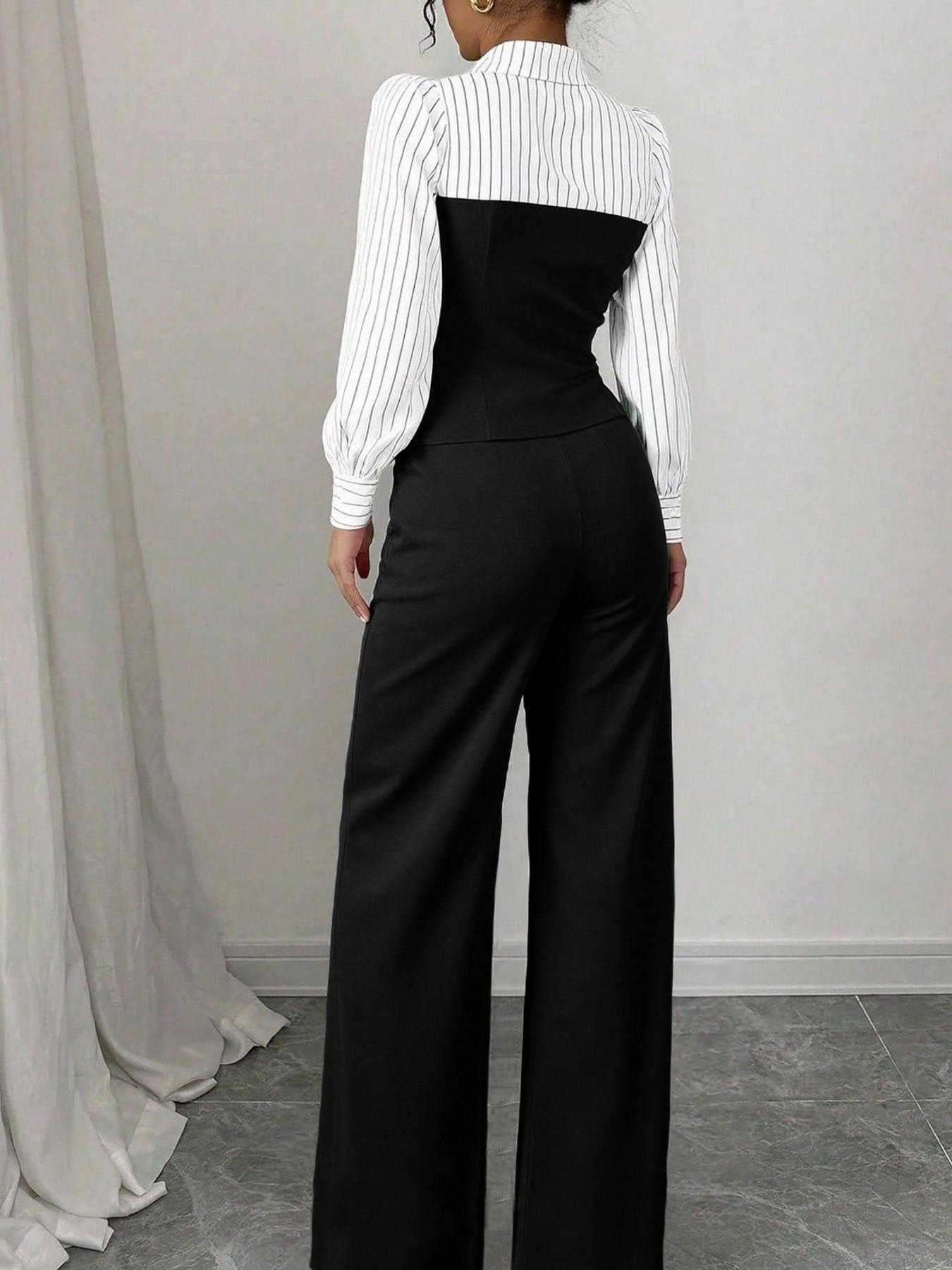 Person wearing a white blouse with a black waistcoat and wide-leg pants against a plain background