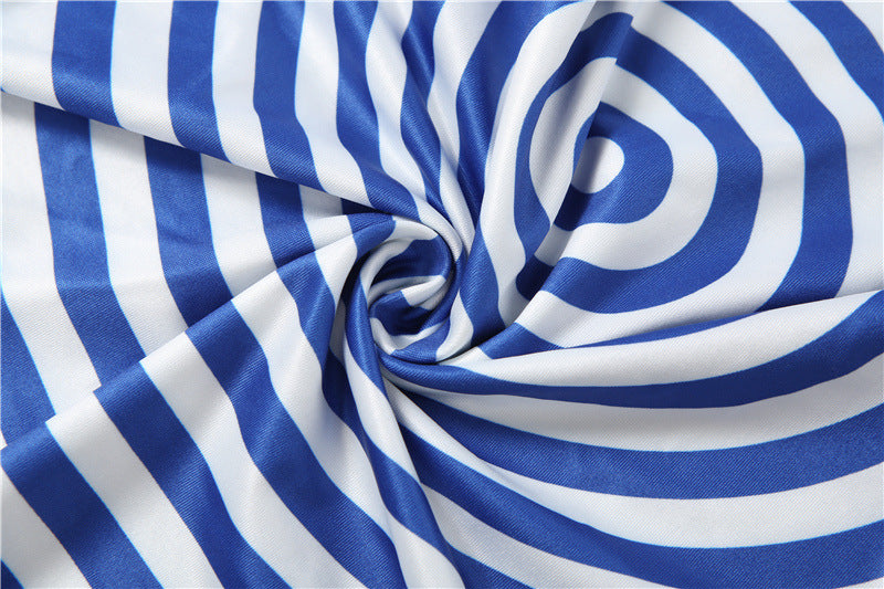 Blue and white striped fabric arranged in a spiral drape, showing a smooth texture and the pattern repeats.