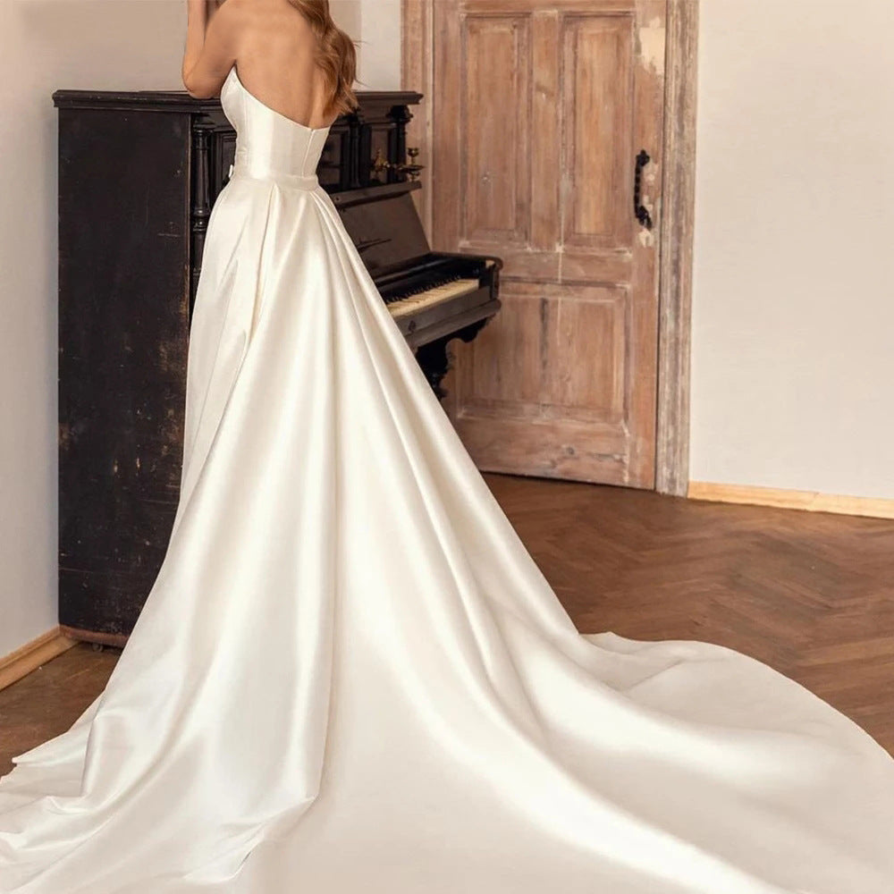 Elegant satin sheath wedding dress with a backless design, high waist fit, and a two-way detachable train for a customizable bridal look.

