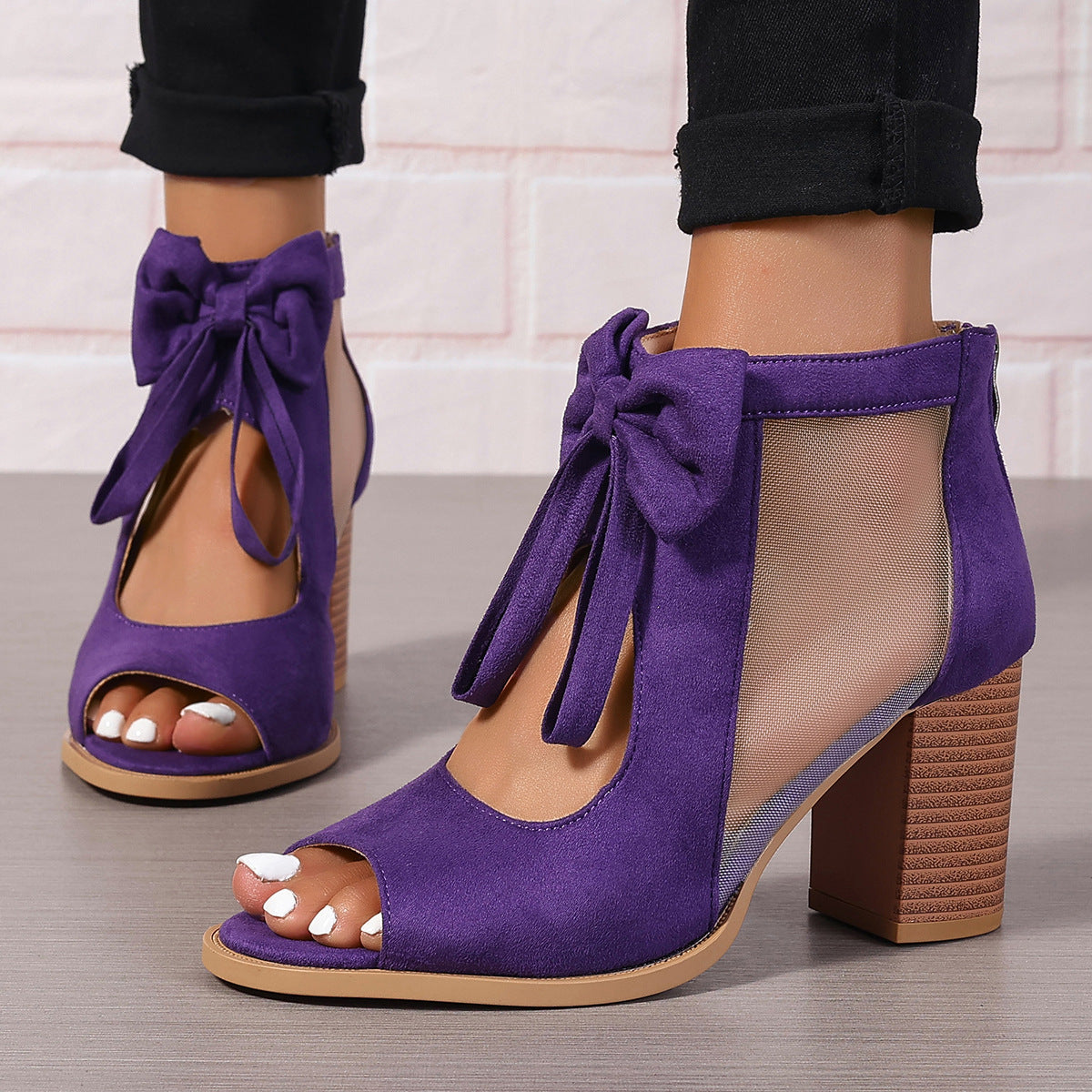Women's platform chunky high heel sandals with bow decoration and ankle strap.

