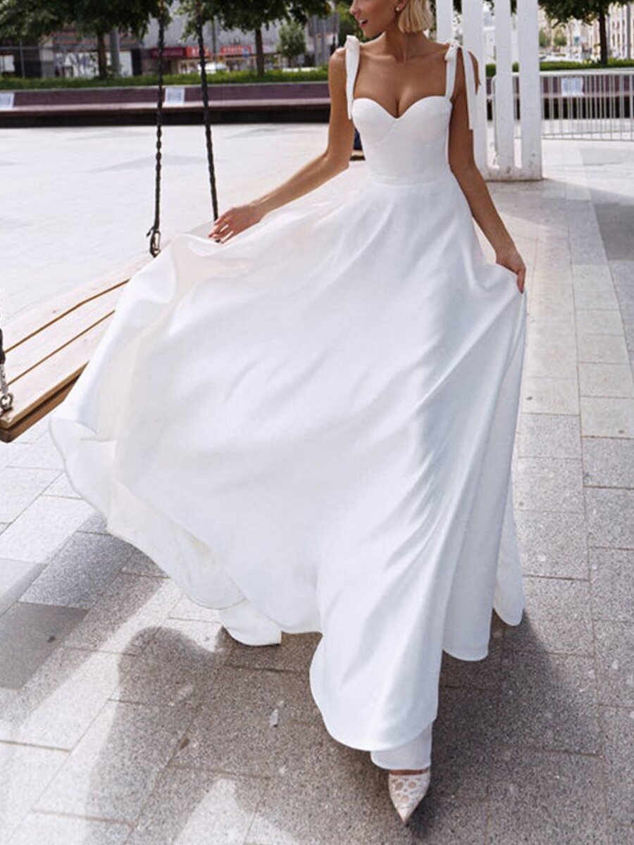 A stylish sexy sling wedding dress featuring a sleek silhouette, delicate straps, and a flowy design, perfect for modern brides.

