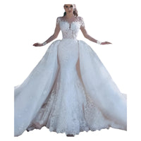 Elegant Africa mermaid wedding dress with long sleeves, lace embroidery, and a dramatic flare for a sophisticated bridal look.


