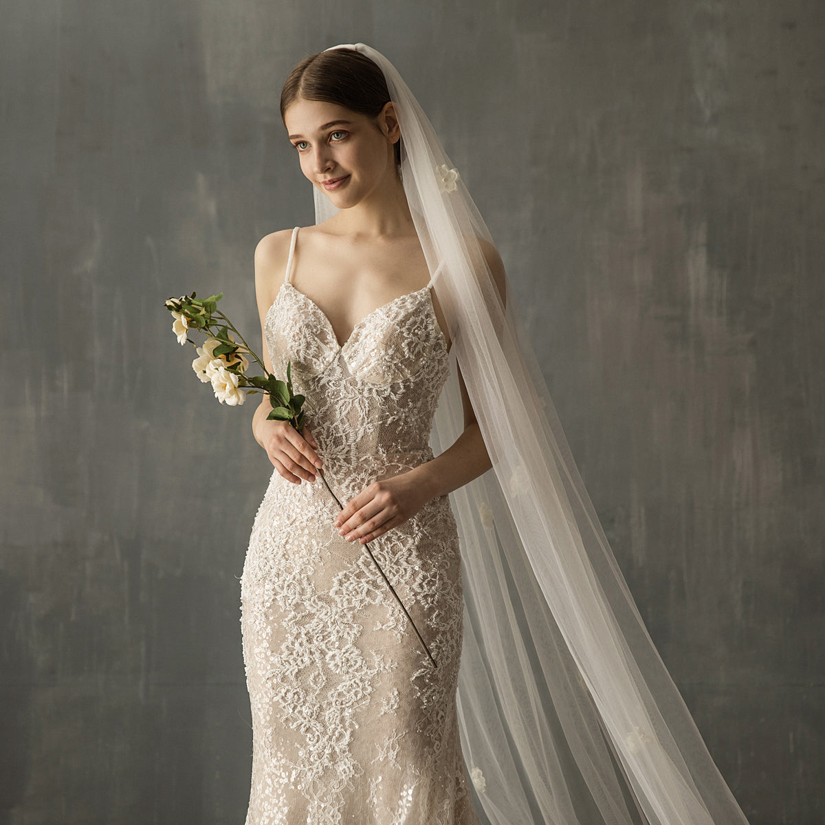 Elegant bridal church wedding veil with pearl embellishments and a long flowing tulle train for a timeless look.


