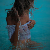 Women's off-shoulder swimsuit top, beach bikini with slubbed fabric, breathable and stylish vacation swimwear.








