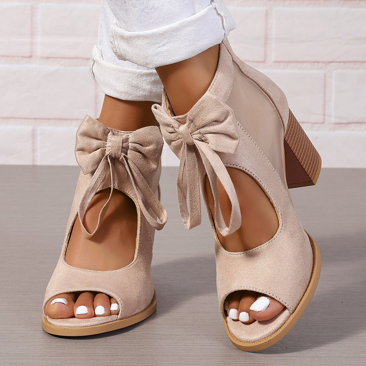 Women's platform chunky high heel sandals with bow decoration and ankle strap.




