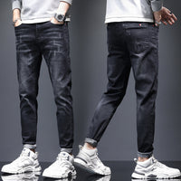 Men's ripped denim jeans with cat-whisker scratch detailing and distressed finish