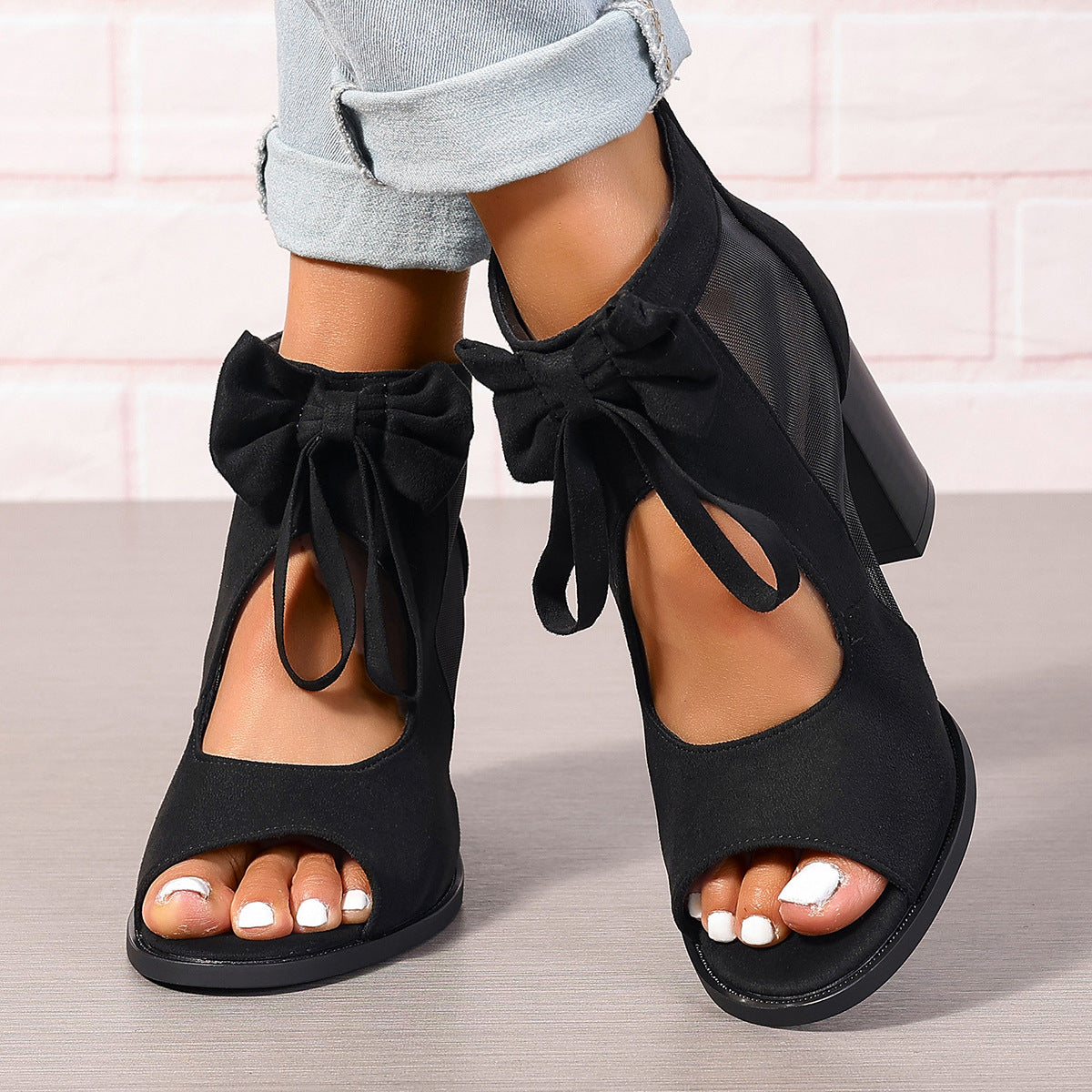 Women's platform chunky high heel sandals with bow decoration and ankle strap.

