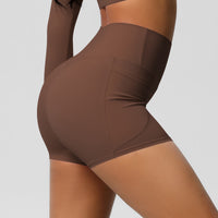 Brown athletic shorts worn by a person on a plain background