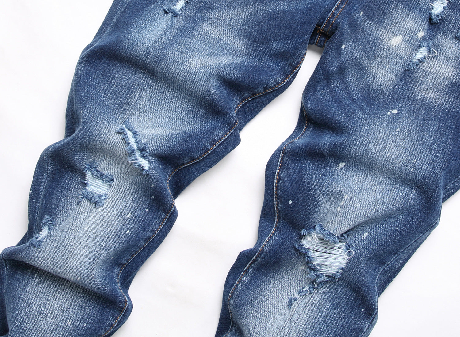 Men’s ripped fashion jeans with ornamental details, slim fit, and distressed design for a trendy streetwear look.