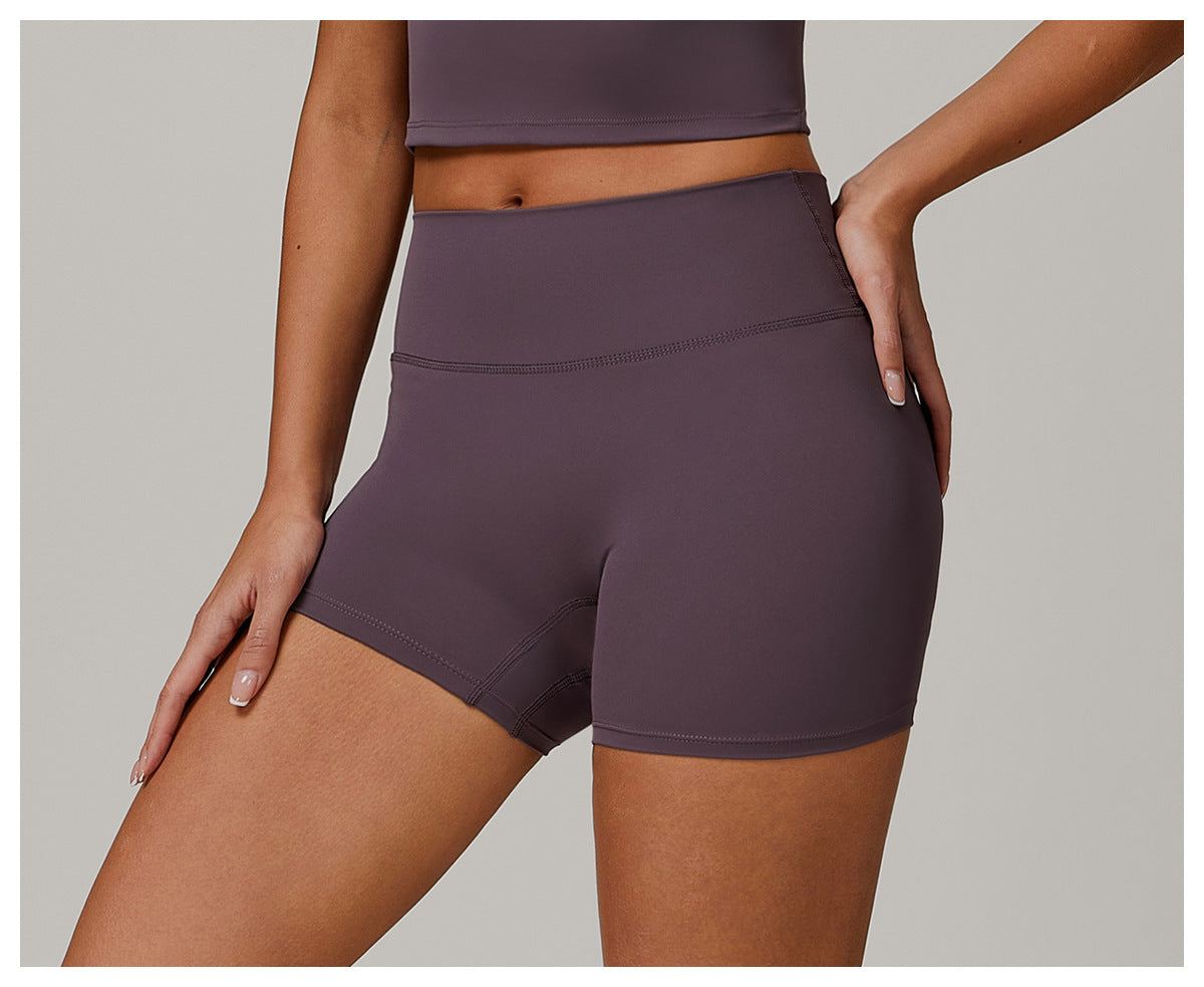 Person wearing purple athletic shorts on a neutral background