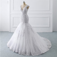 A luxurious mermaid wedding dress with a light trailing train, French retro design, and delicate lace details, perfect for an elegant and slim bridal look.

