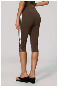 Brown capri leggings with white stripes on a plain background