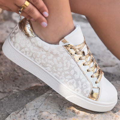 Women's white sneakers with vintage leopard print accents, stylish and comfortable.


