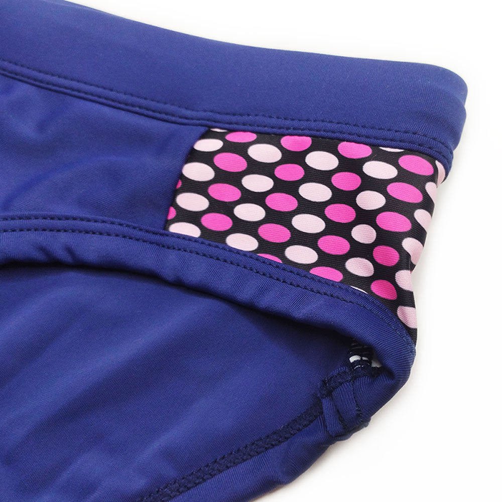 Men’s close-fitting swim briefs with polka dot stitching, designed for beach and sports activities.

